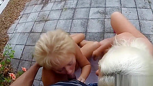 Two mature blondes sucking one black dick