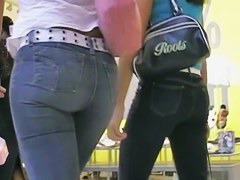 Two sexy babes in tight jeans strolling in the mall
