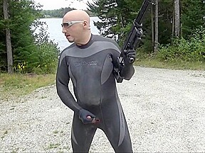 Wetsuited Silicone Masked Man On Patrol Near Lake