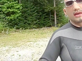 Wetsuited Silicone Masked Man On Patrol Near Lake