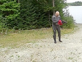 Wetsuited Silicone Masked Man On Patrol Near Lake