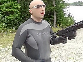 Wetsuited Silicone Masked Man On Patrol Near Lake