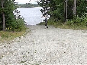 Wetsuited Silicone Masked Man On Patrol Near Lake