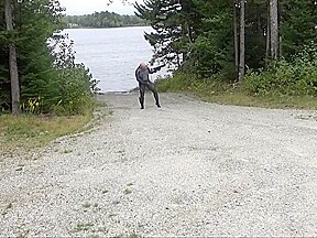 Wetsuited Silicone Masked Man On Patrol Near Lake