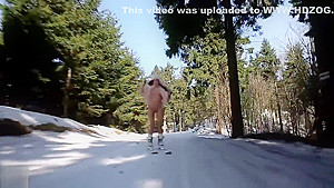 Woman skiing naked and masturbating lying on the snow