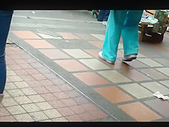 a beautiful round ass in jeans talking at a public phone