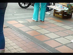 a beautiful round ass in jeans talking at a public phone