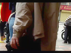 a beautiful round ass in jeans talking at a public phone