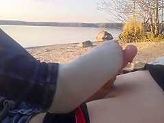public footjob and socksjob on the beach